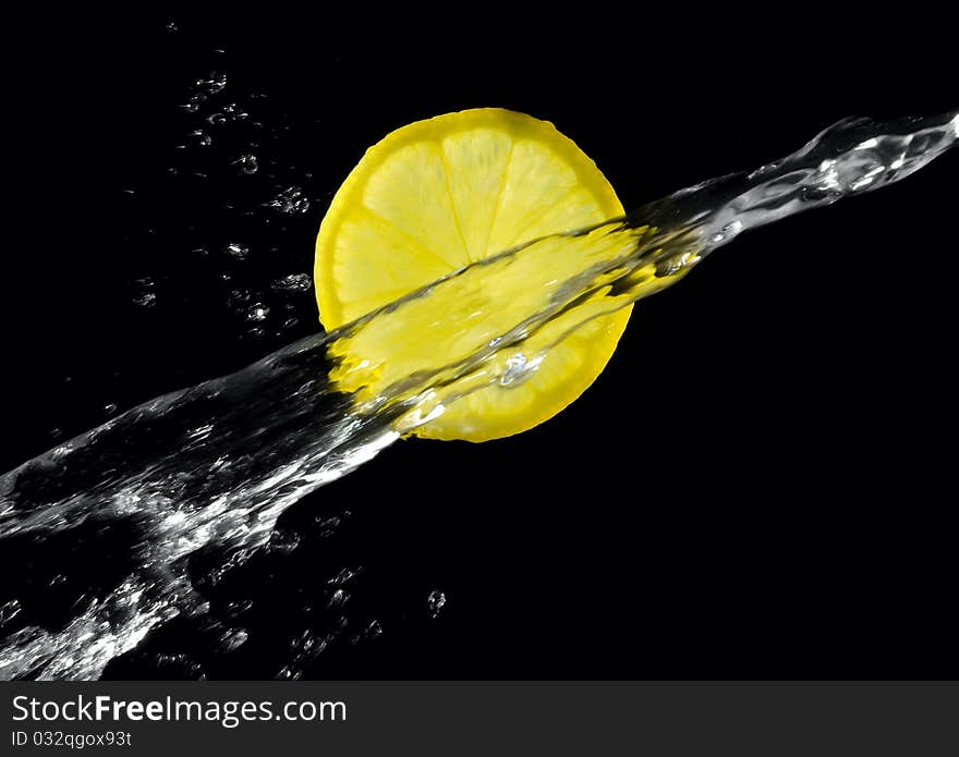 Lemon with splashing water on a black background. Lemon with splashing water on a black background