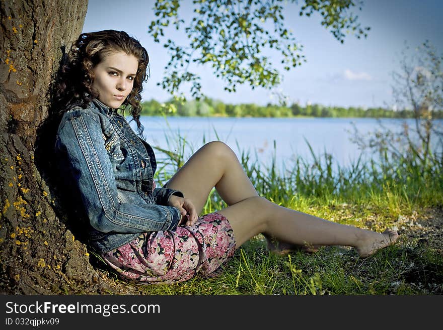 Beautiful Young Woman Relaxing Near River