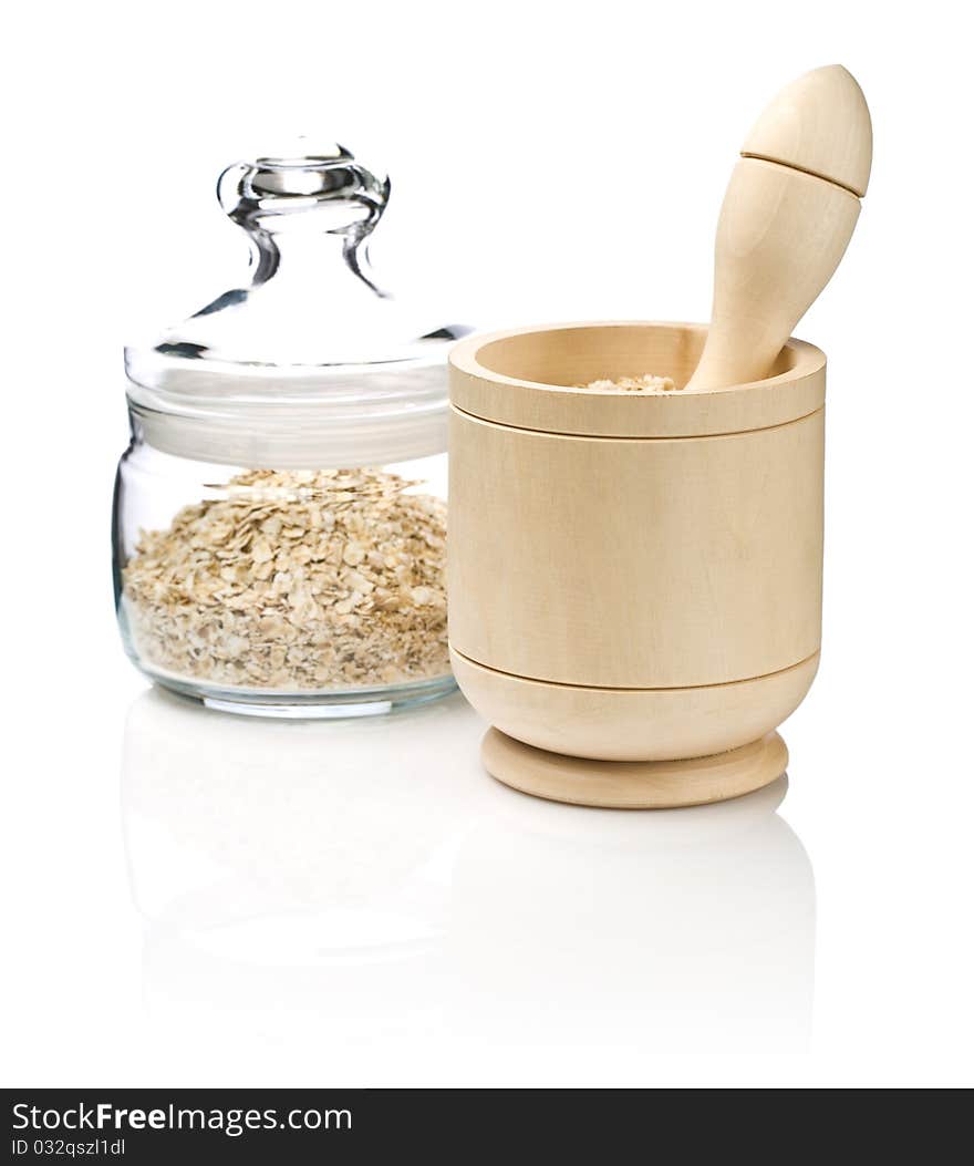 Wooden mortar and glass jar with cereals isolated on white background