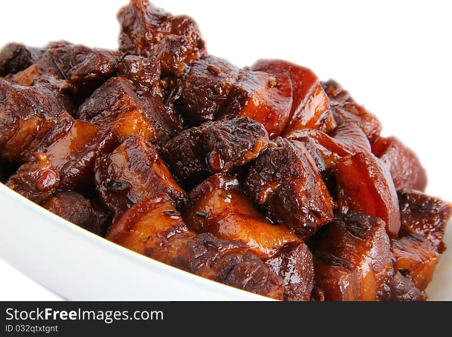 Chinese pork meat stew. Close up on white background