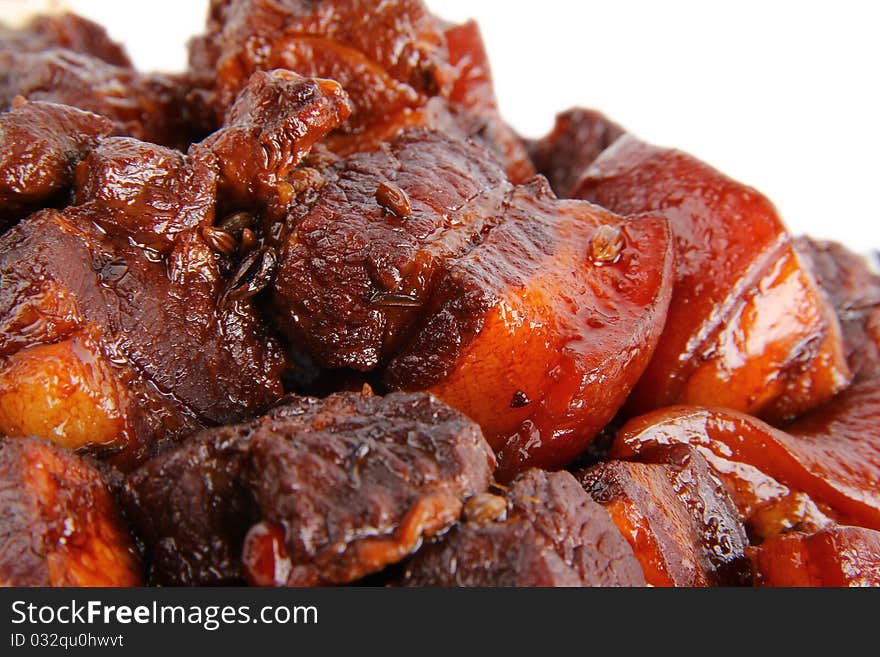 Chinese pork meat stew. Close up on white background