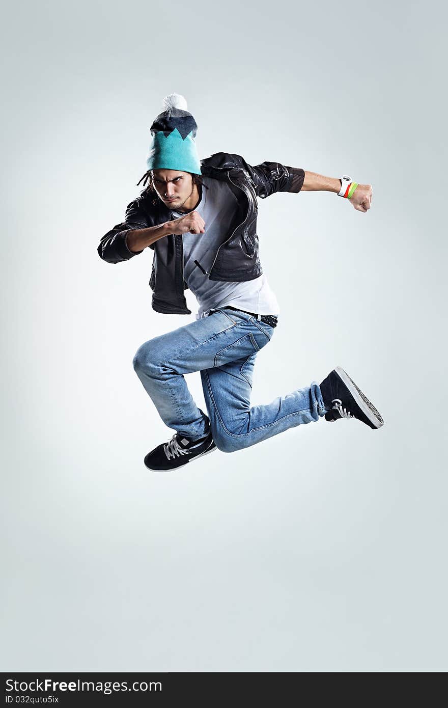 Modern style dancer jumping on studio background. Modern style dancer jumping on studio background