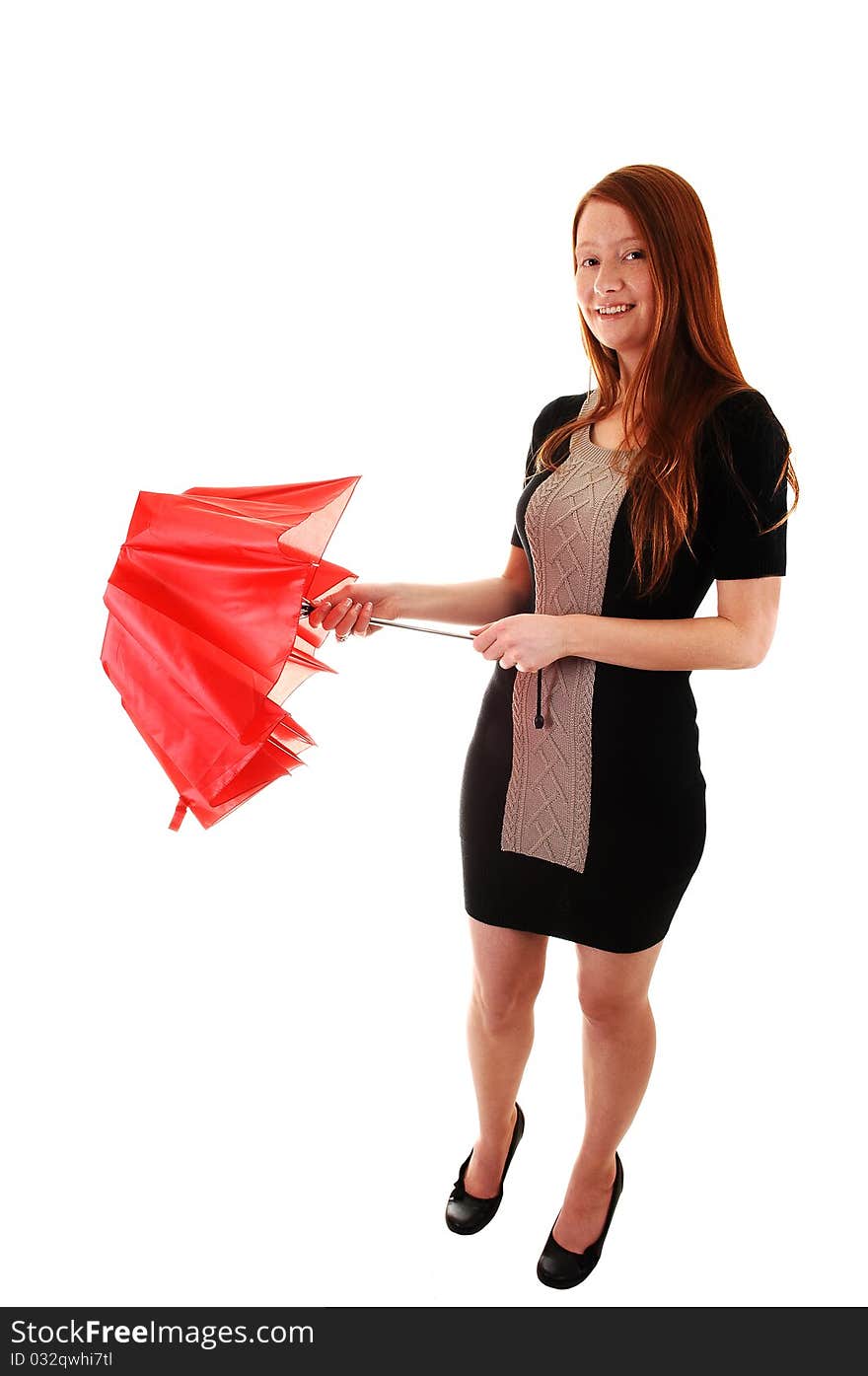 A pretty red haired woman in a black dress holding a red umbrella
in her hand, looking into the camera, on white background. A pretty red haired woman in a black dress holding a red umbrella
in her hand, looking into the camera, on white background.