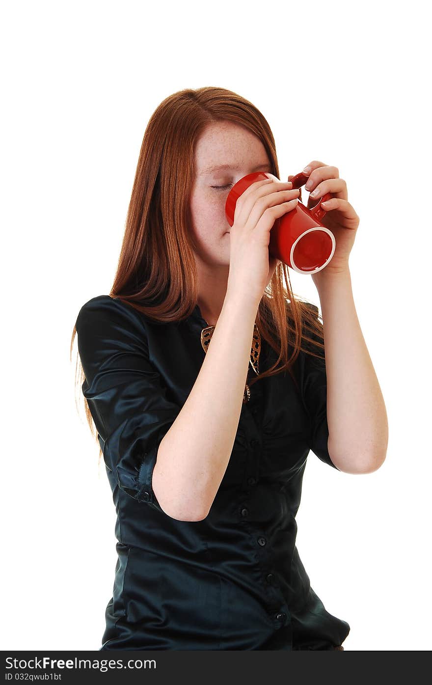 A young woman with long red hair and a mug of coffee, in a green blouse for white background. A young woman with long red hair and a mug of coffee, in a green blouse for white background.