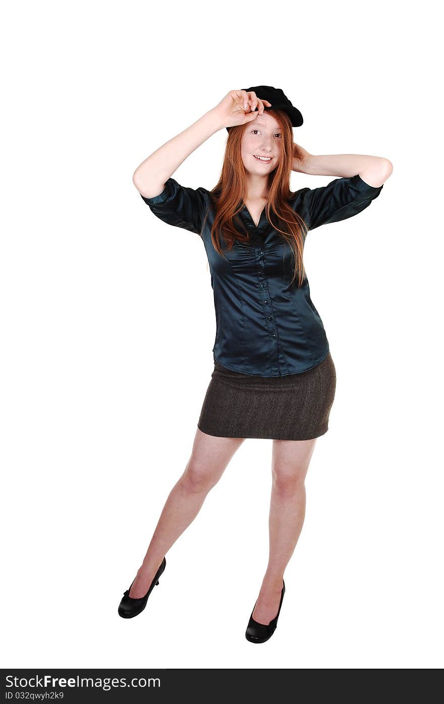 A young pretty woman with long red hair in a green blouse wearing a hat with buttons on, for white background. A young pretty woman with long red hair in a green blouse wearing a hat with buttons on, for white background.