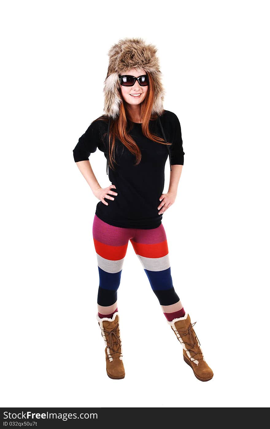 A pretty woman with long red hair in colorful tights, a black sweater 
and a fur hat and brown boots smiling for a portrait for white background. A pretty woman with long red hair in colorful tights, a black sweater 
and a fur hat and brown boots smiling for a portrait for white background.