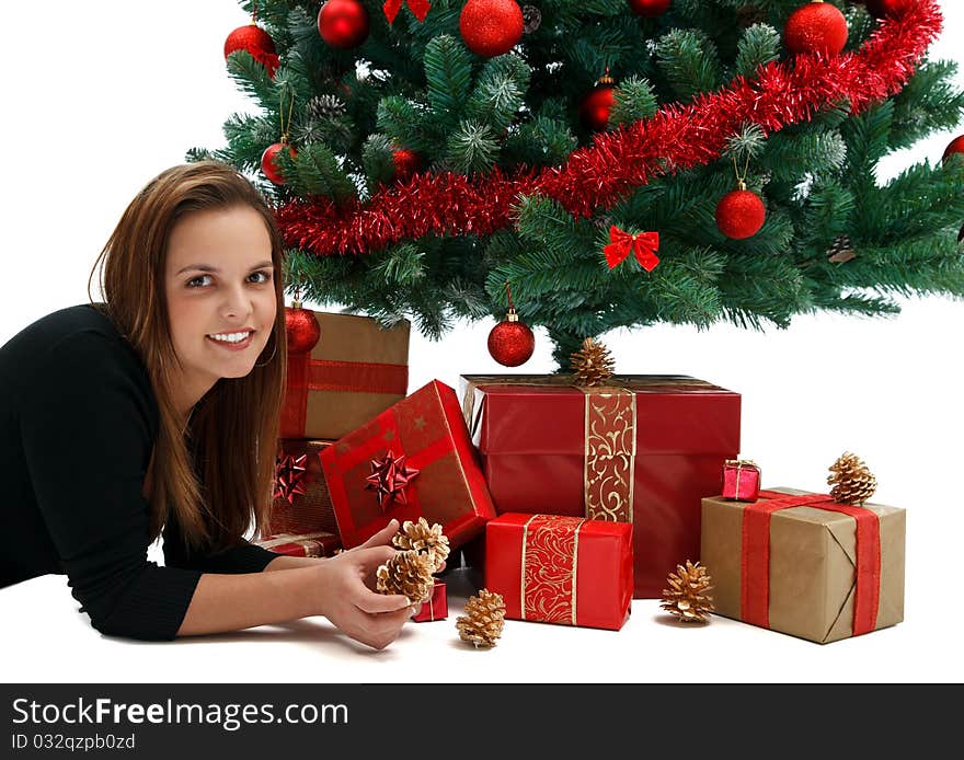 Young beautiful girl near the Christmas tree with lots of presents. Young beautiful girl near the Christmas tree with lots of presents