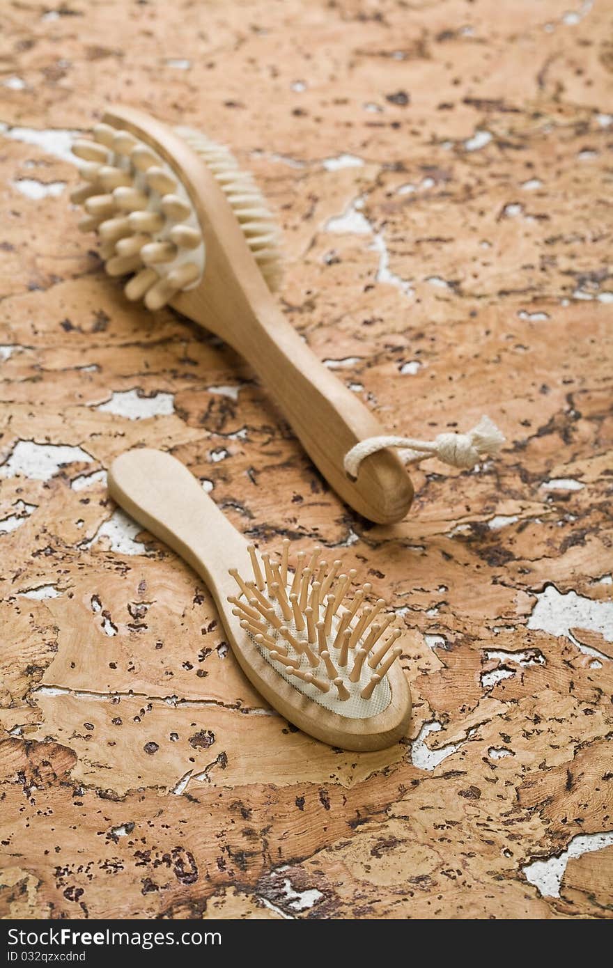 Massager And Hairbrush On Cork Wood