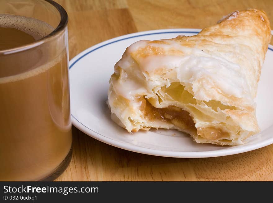 Coffee and an fresh apple turnover for breakfast. Coffee and an fresh apple turnover for breakfast