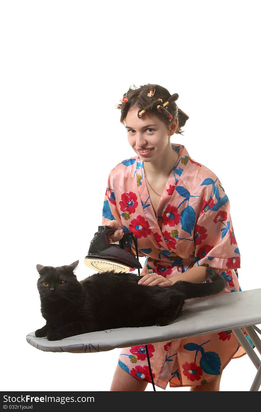 Attractive housewife ironing a black cat. Attractive housewife ironing a black cat