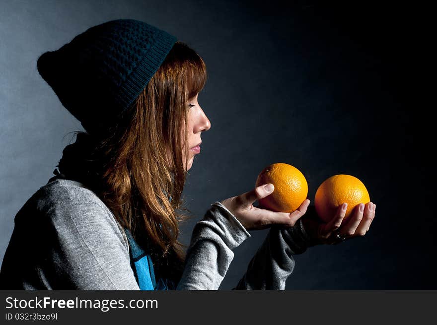 Girl with orange and hat with black background