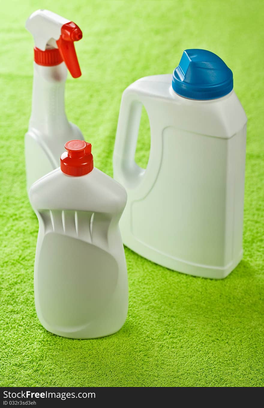 Three white bottles on green background