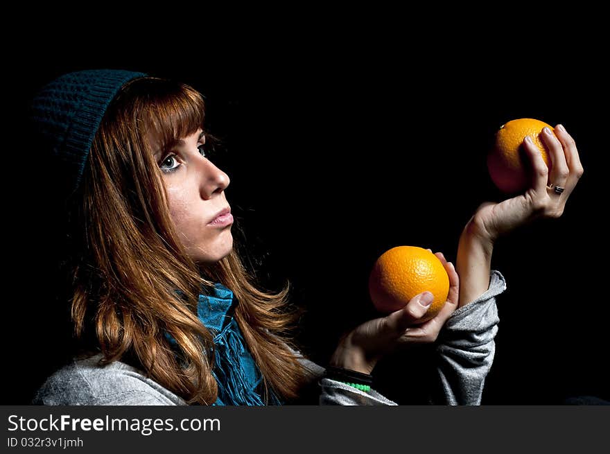 Girl with orange and hat with black background