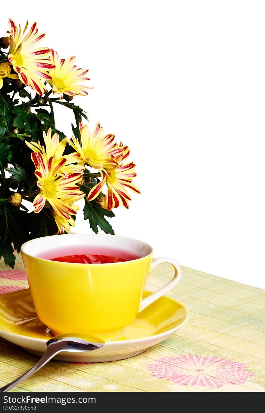 Cup of red tea and chrysanthemum flowers