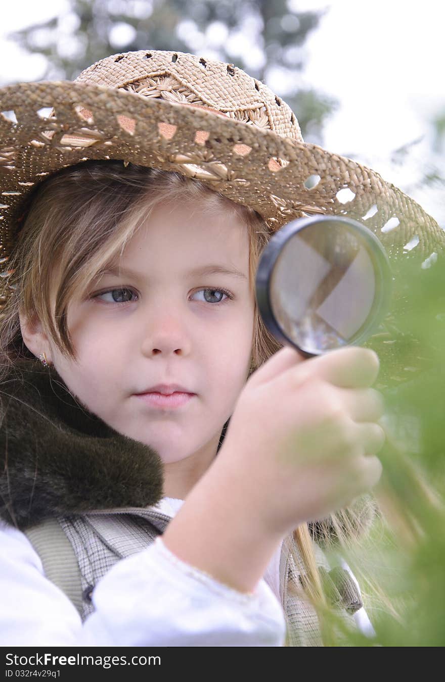 Girl with magnifying glass