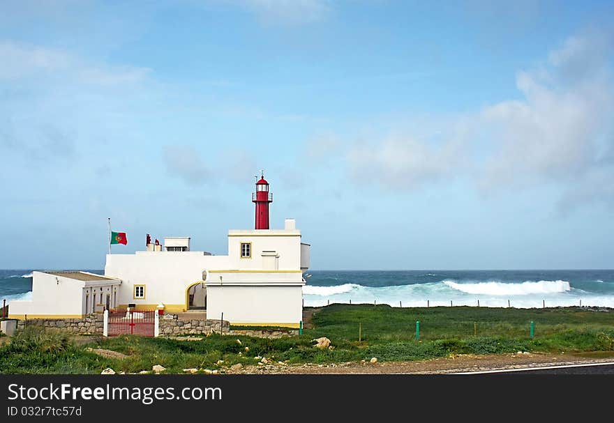 Lighthouse shallow cape with wavy sea as background