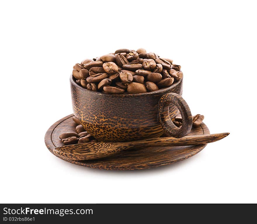 Brown wooden cup of teak tree with coffee beans