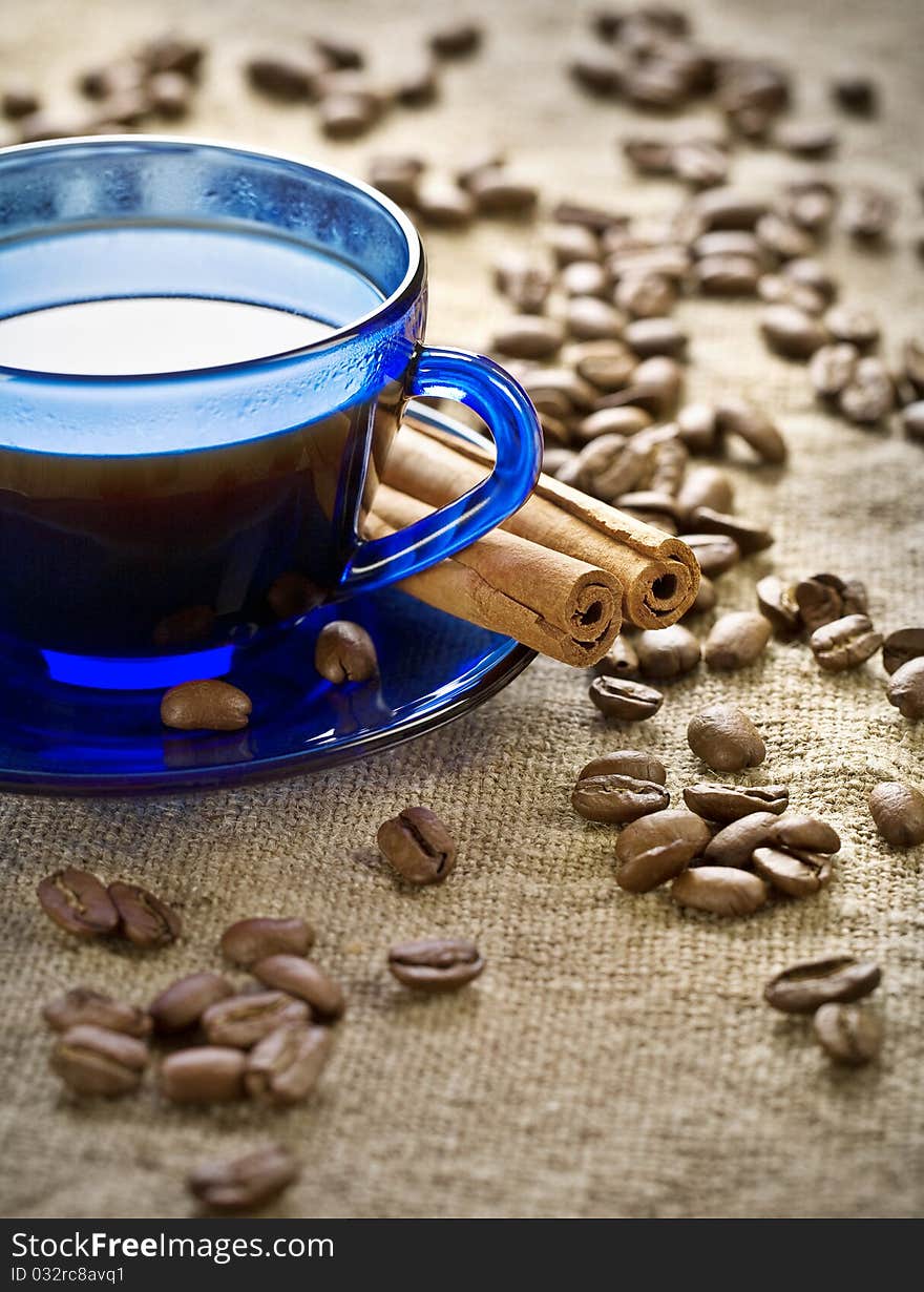 Cinnamon And Coffee Beans With Cup On Saucer