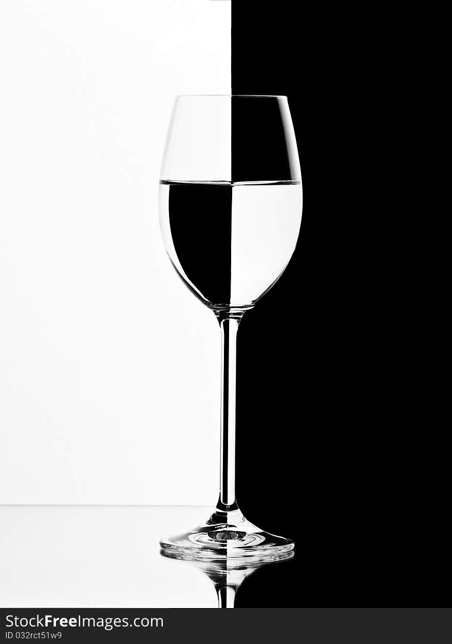 One abstract glass with water isolated on white and black background