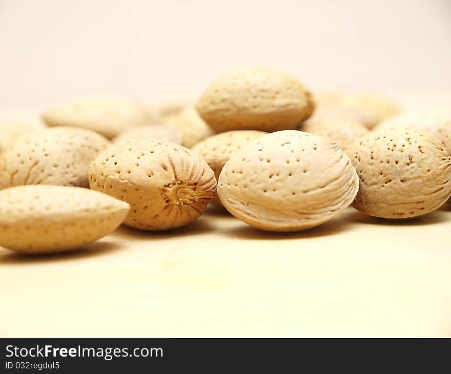 Some unshelled almonds on a table