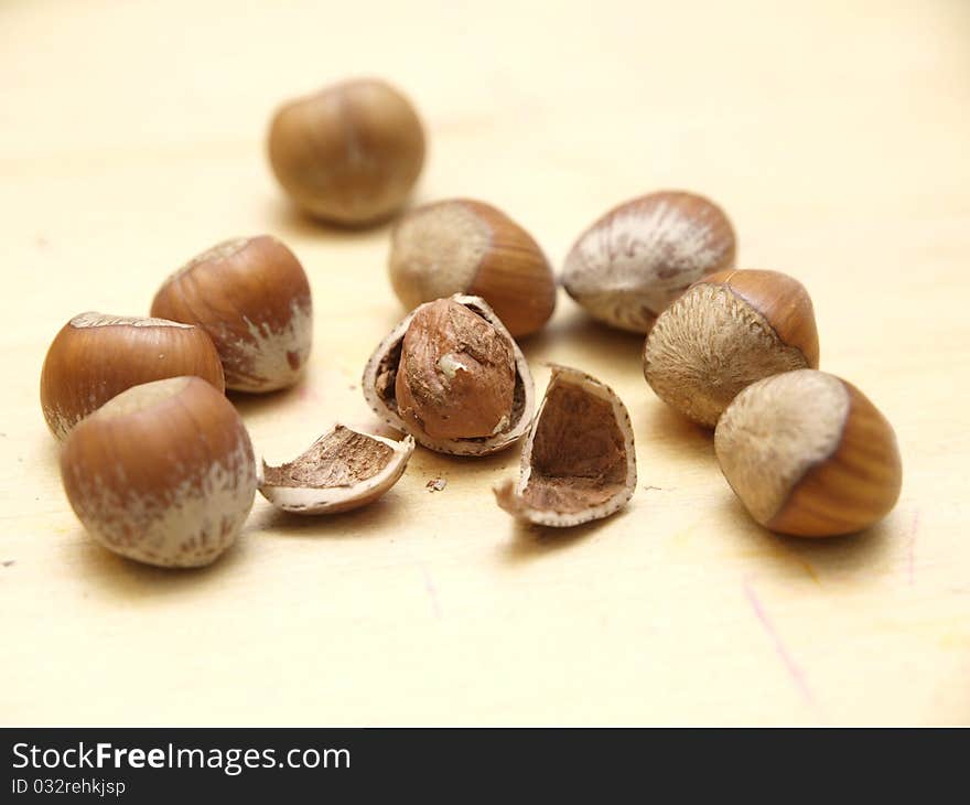 Hazelnuts on a table, one shelled