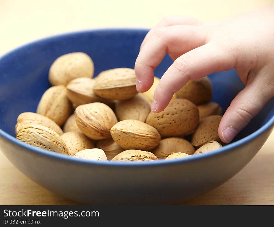 A child´s hand getting almonds