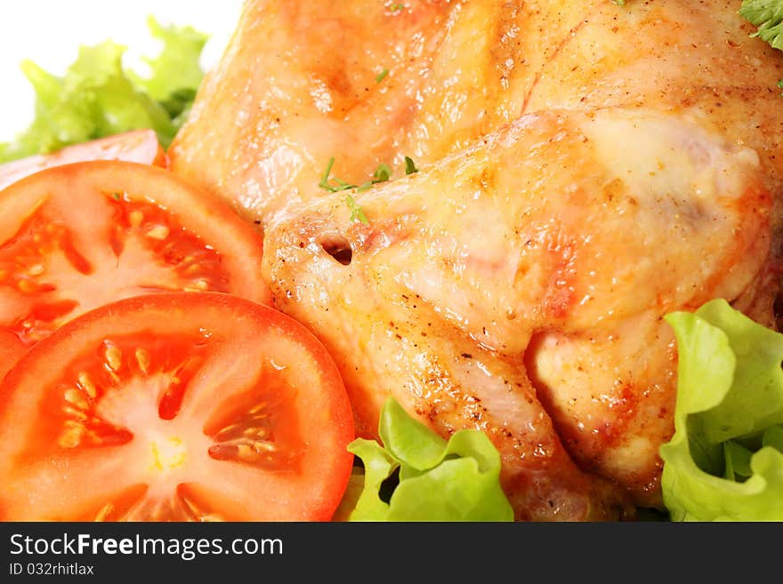 Roast chicken on leaves salad on a white background is isolated. Roast chicken on leaves salad on a white background is isolated.