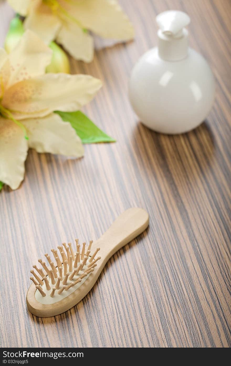 Round Bottle And Hairbrush With Flower