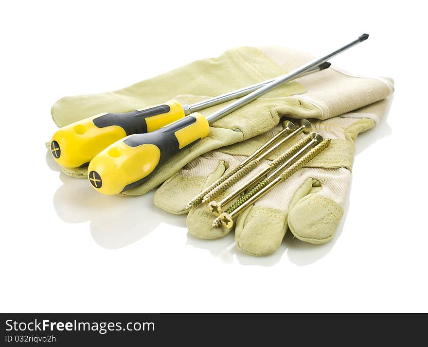 Screwdriver and screws on gloves isolated on white background