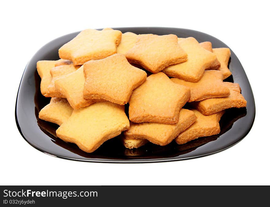 Asterisk cookies on a plate, on a white background it is isolated. Asterisk cookies on a plate, on a white background it is isolated.