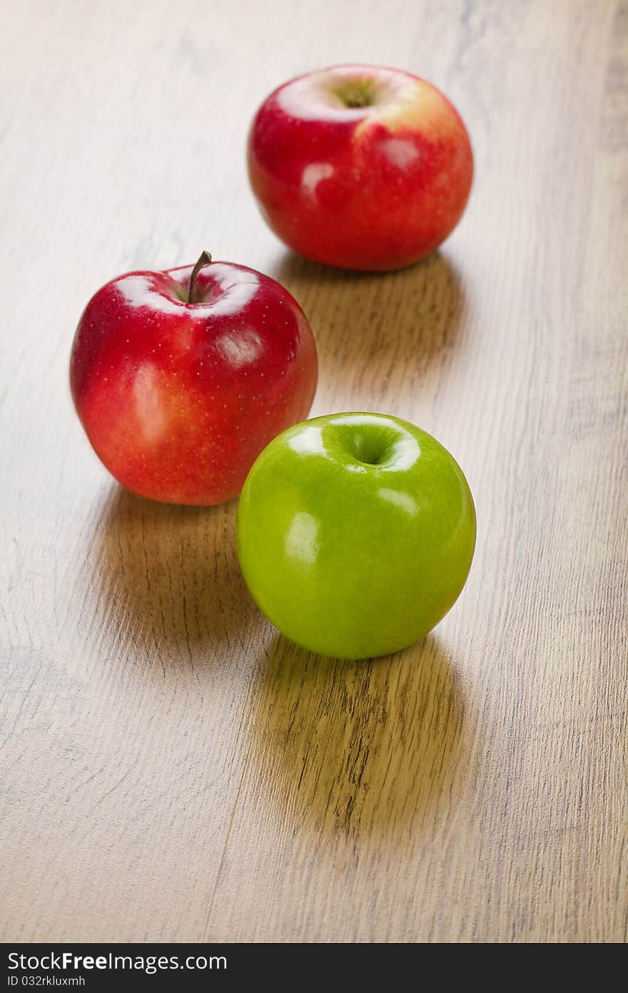 Three apples
red and green
wooden background