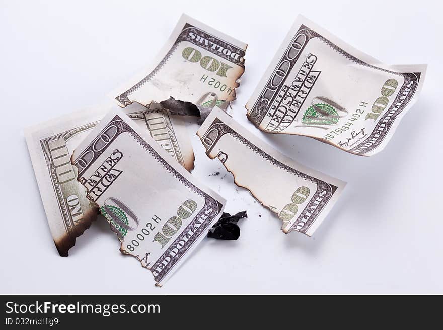 Burned dollar bills on white background. Burned dollar bills on white background