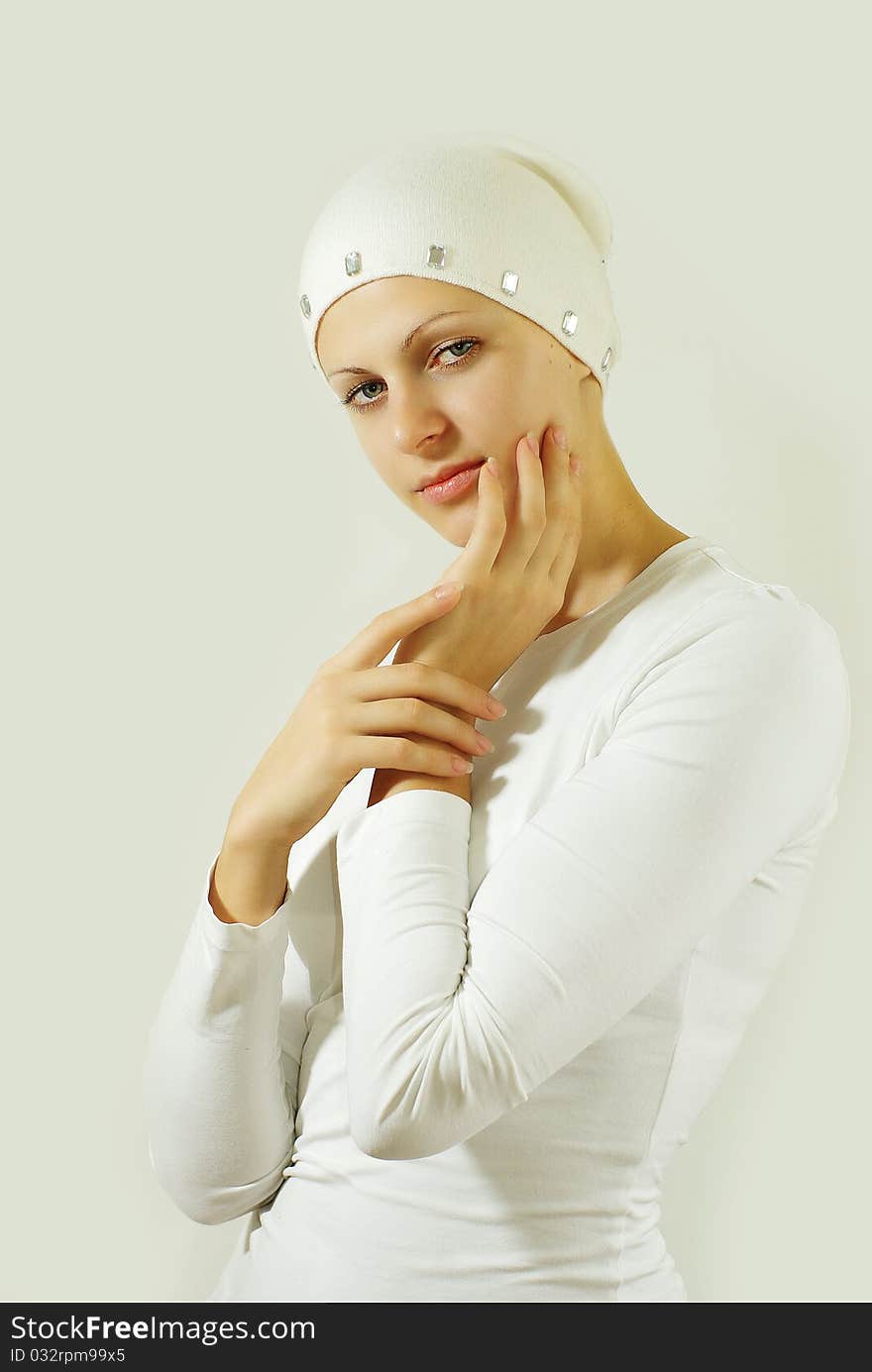 Attrective girl posing against grey wall