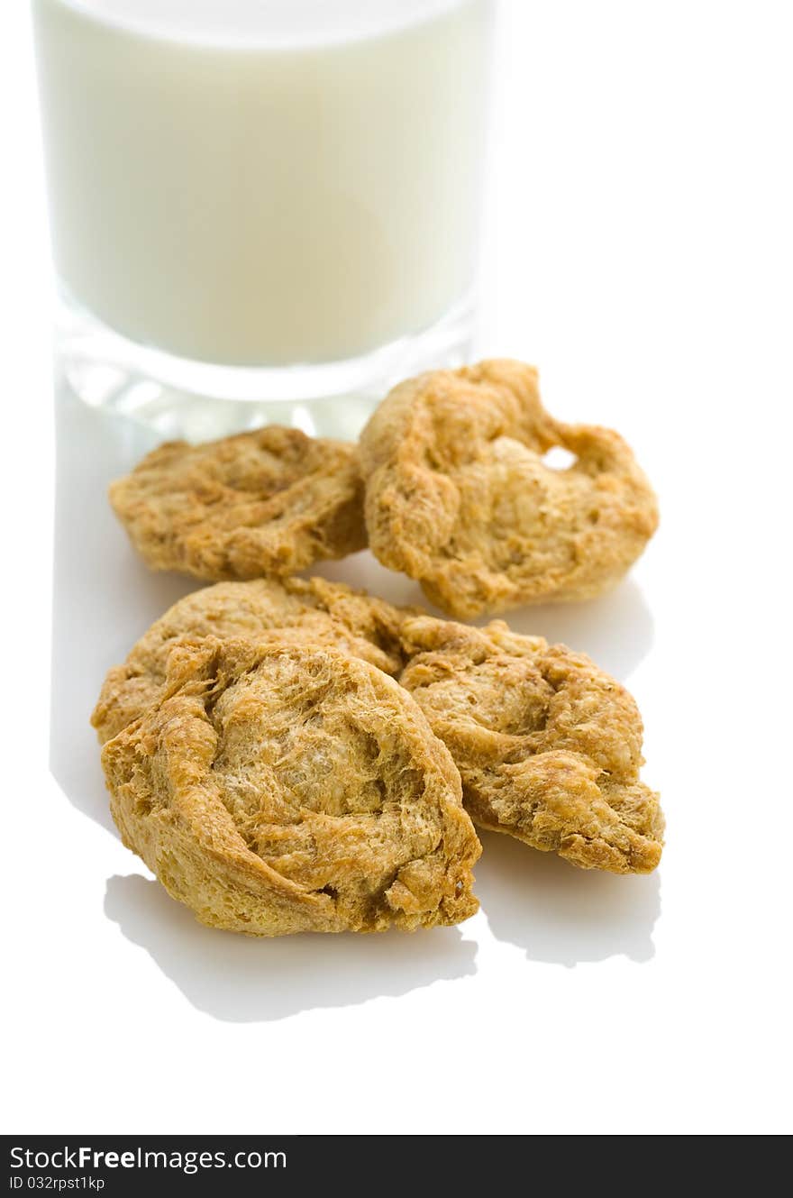 Glass of milk with cookies isolated on white background