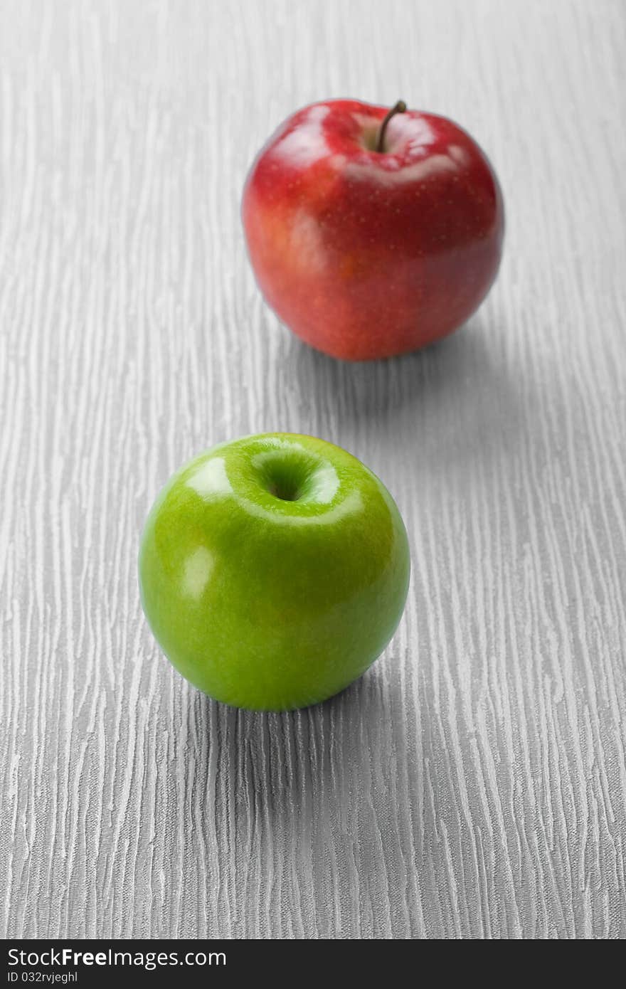 Two apples on abstract gray background