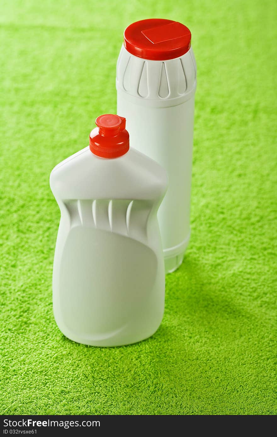 Two bottles on green background