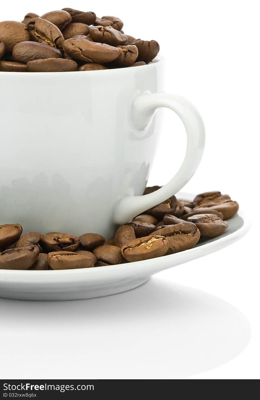 Ceramical white coffee cup and brown beans isolated on white background. Ceramical white coffee cup and brown beans isolated on white background