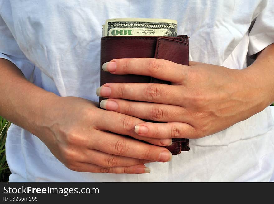 Women s hands and purse with dollars