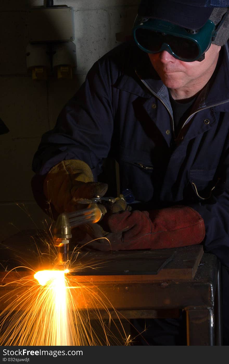 Close up of welder with orange sparks