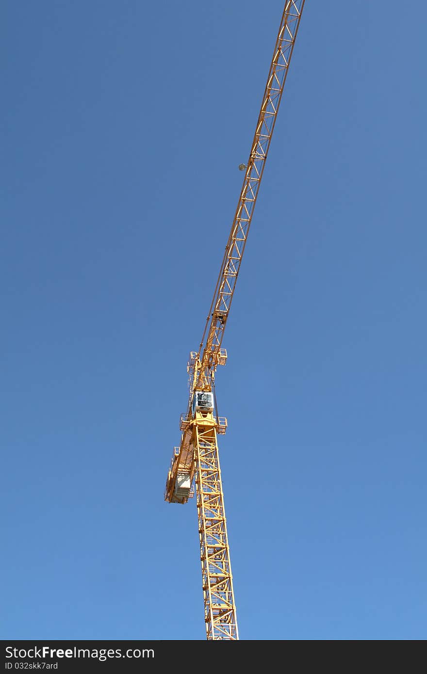 High-rise construction crane against blue sky