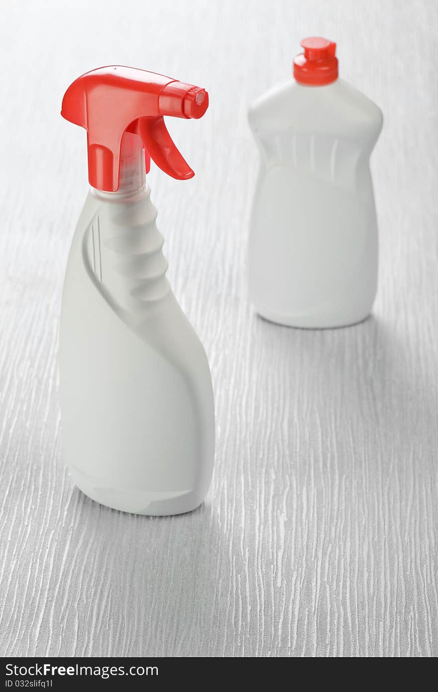 White spray cleaners on gray background. White spray cleaners on gray background