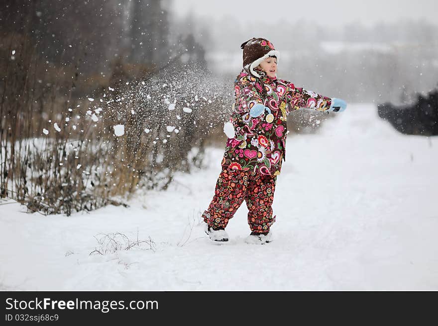 Small girl in strong snow fall