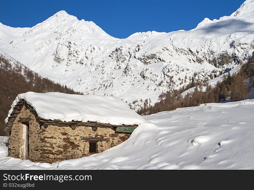 Cabins in a mountain valley in the North of Italy during winter. Brixia province, Lombardy region, Italy. Cabins in a mountain valley in the North of Italy during winter. Brixia province, Lombardy region, Italy