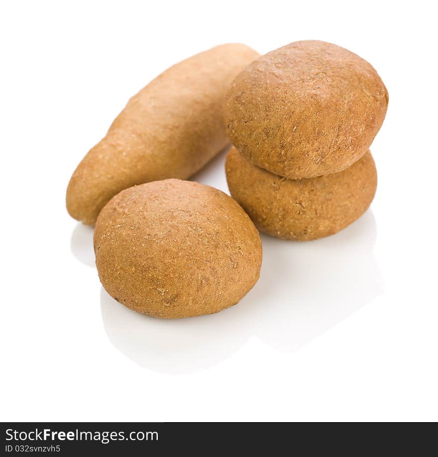 One long and three round loafs of bread isolated on white background