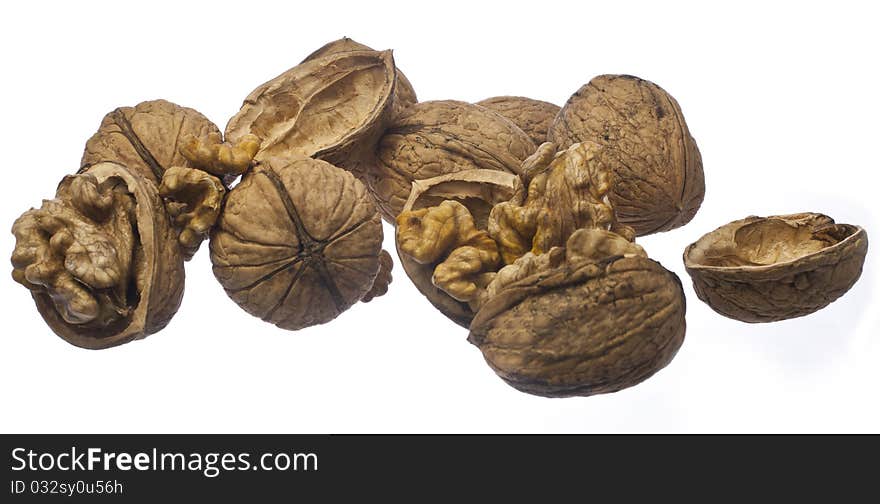 Whole walnuts and cracked walnuts on a white background. Whole walnuts and cracked walnuts on a white background