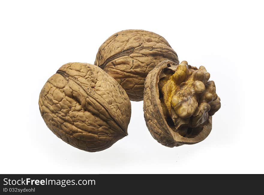 Whole walnuts and cracked walnuts on a white background. Whole walnuts and cracked walnuts on a white background