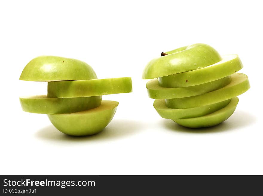 Green sliced apples isolated on white background