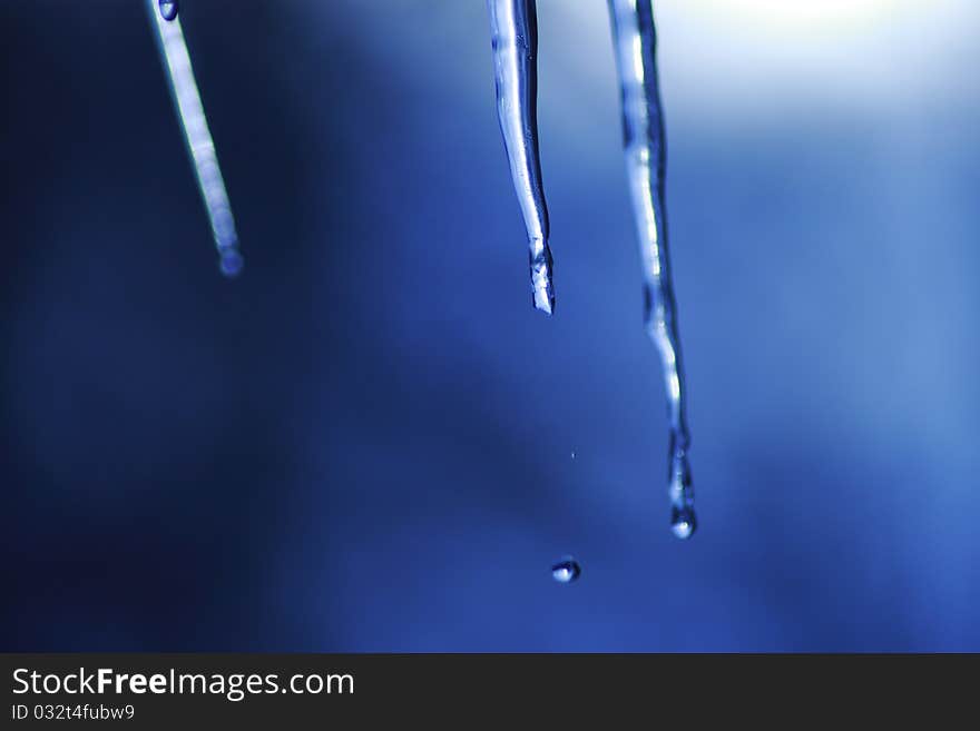 Icicle coming down from our roof. The blurred background is the sky. December 2010. Icicle coming down from our roof. The blurred background is the sky. December 2010