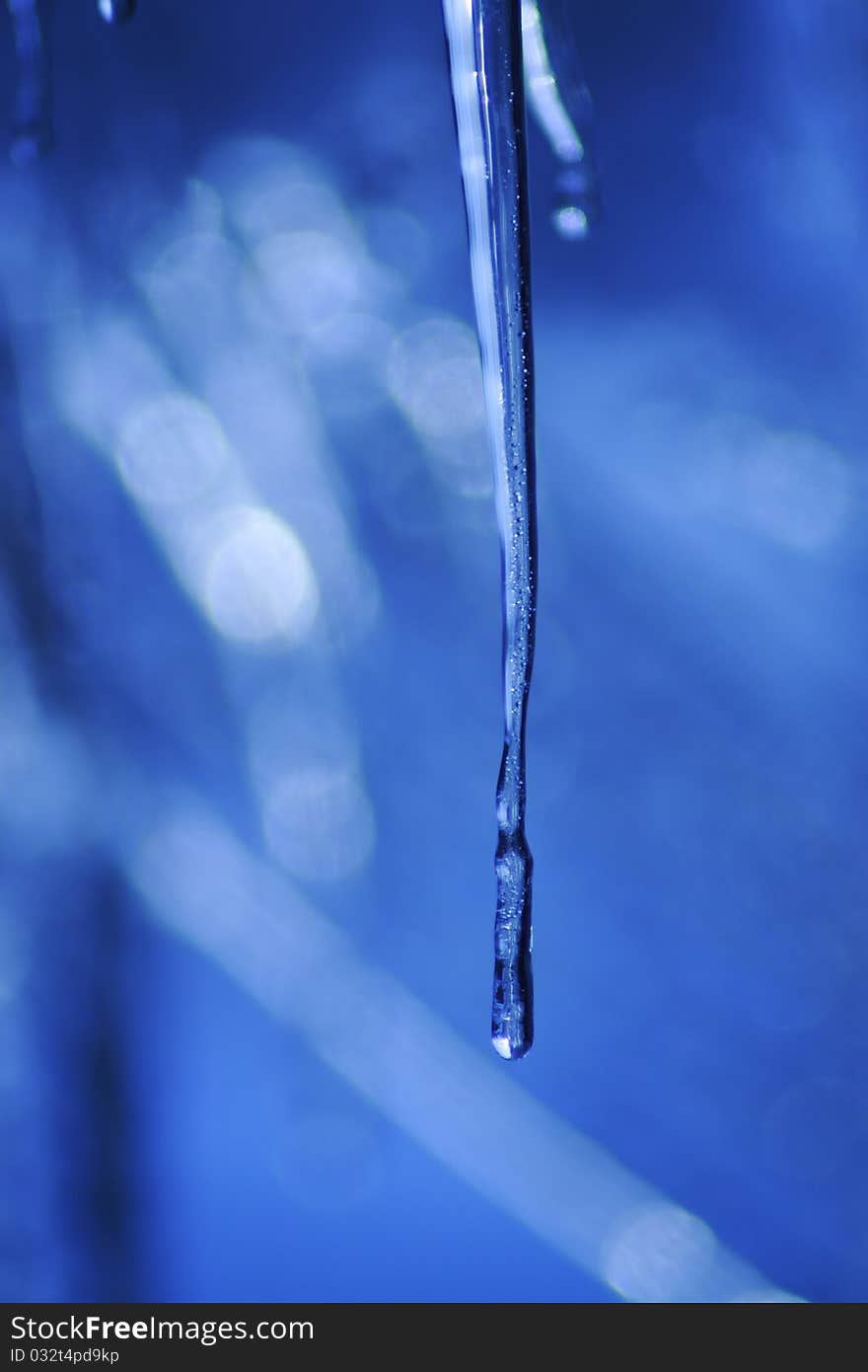 Icicle coming down from our roof. The blurred background is the sky. December 2010. Icicle coming down from our roof. The blurred background is the sky. December 2010