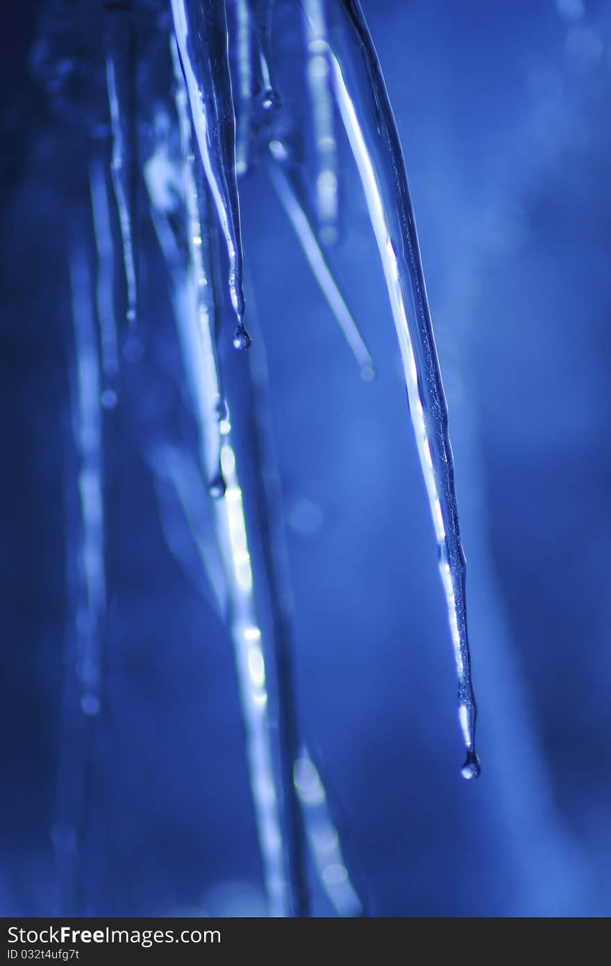 Icicle coming down from our roof. The blurred background is the sky. December 2010. Icicle coming down from our roof. The blurred background is the sky. December 2010